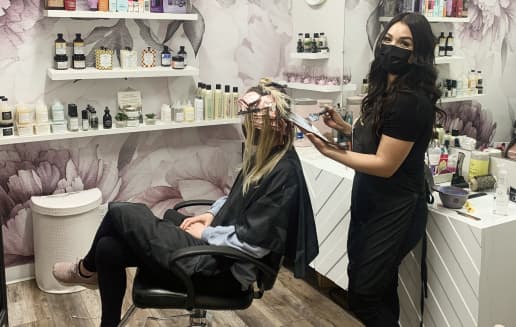 A stylist in their suite working with a client